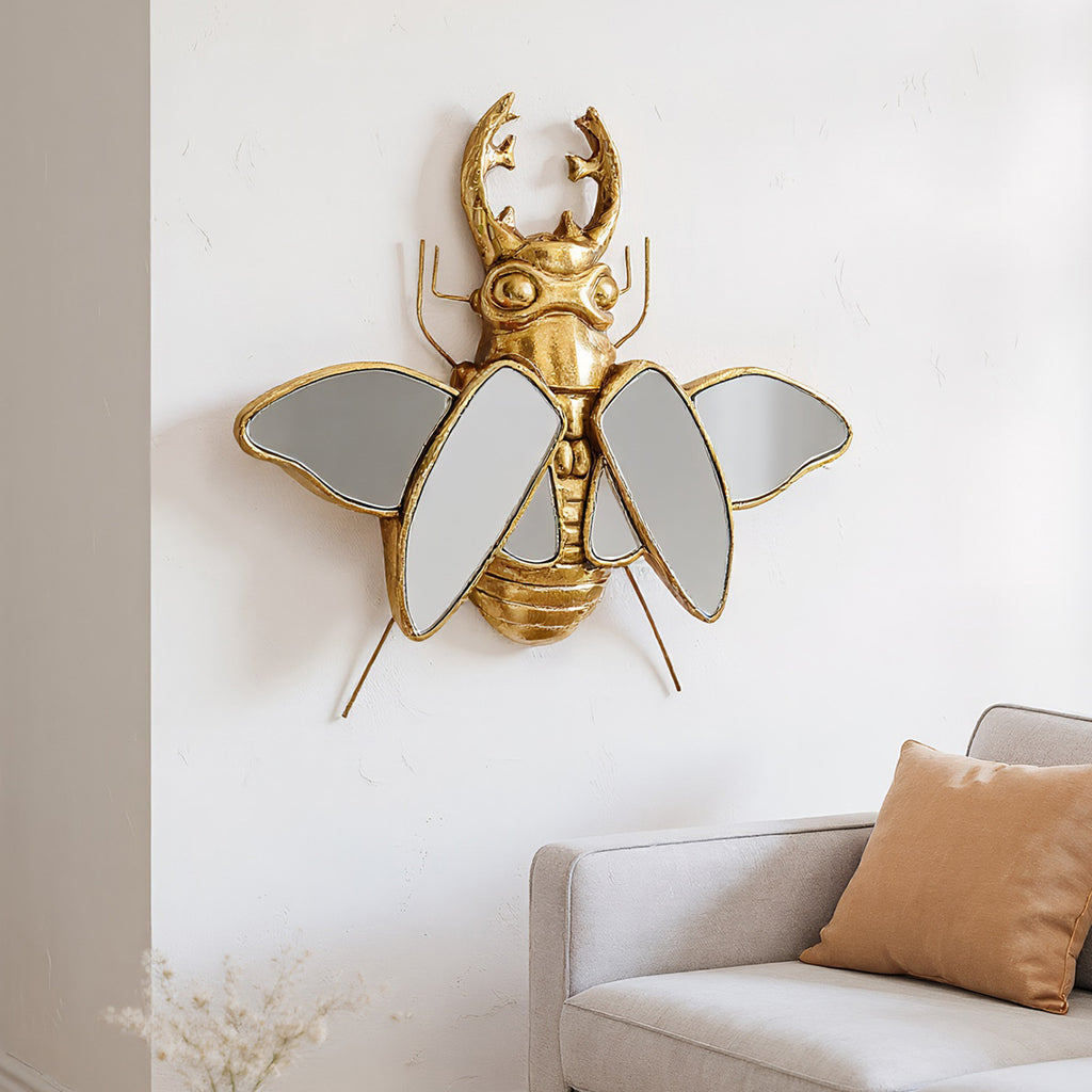 Mirror wall decoration with winged beetle