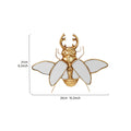 Mirror wall decoration with winged beetle