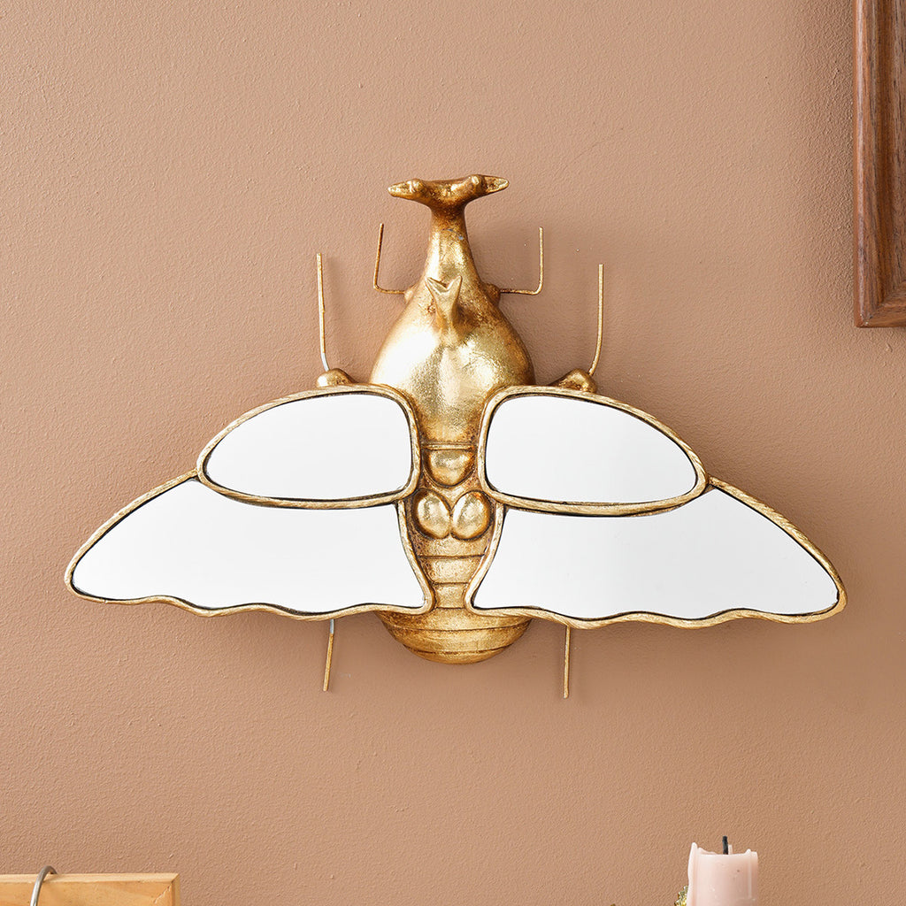 Mirror wall decoration with winged beetle